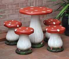 four red and white mushrooms sitting on top of each other