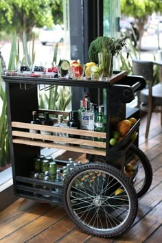 an outdoor bar cart filled with drinks and fruit