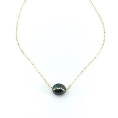 "The \"little black dress\" of necklaces. Our Floating Tahitian Pearl Necklace adds a timeless elegance to every outfit, the perfect accessory for every occasion. This necklace features one beautiful Tahitian Pearl on a delicate metal chain of your choice. In the drop down menu you may choose your preferred chain length as well as your preferred metal chain: Sterling Silver, 14k Gold Fill or 14k Rose Gold Fill. PLEASE NOTE: The genuine Tahitian Pearls will vary in shape, size and color and will Tahitian Pearls Jewelry, Tahitian Pearl Ring, Pearl Necklace Gold, Black Pearl Necklace, Tahitian Pearl Necklace, Mermaid Jewelry, Floating Necklace, The Little Black Dress, Pearl Bangle