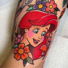 a woman's leg with an image of ariel from the little mermaid on it