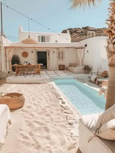 a house with a pool in the middle of it and some palm trees around it