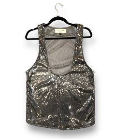 Add some disco flair to your wardrobe with this sequin tank, featuring a soft and breathable mesh detail in the back. Glamorous Summer Vest With Sequins, Sequined Summer Tank Top, Sequined Tank Top For Summer, Summer Sequin Tank Top, Chic Sequined Summer Vest, Embellished Stretch Mesh Top For Summer, Sequined Mesh Top For Night Out, Fitted Sequined Mesh Top For Club, Summer Party Tank Vest