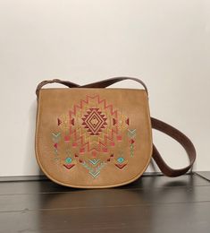 To see more treasures that need  a home please visit!! Myvintagelittlestore.etsy.com This listing is for a beautiful Light Tan with Brown Catchfly Kristan crossbody/shoulder purse on the front it has a beautiful Aztec Embroidery design. It measures 26 inches and has 5 more inches left to make it longer. this purse Features.   -1 Compartment  -1 zip pocket - Front swap pocket Front Flap Magnetic snap closure  -1 Organize pocket  For more details please zoom in on the  pictures and if you need any more or have any questions please don't hesitate to send me a message I will gladly send them to you, Thank you for stopping by  you are welcome to come back anytime...  All my items are sold vintage I try to describe them to the best of my ability, they may have some imperfections due to age and w Embroidered Brown Rectangular Satchel, Brown Embroidered Rectangular Satchel, Embroidered Brown Crossbody Shoulder Bag, Brown Embroidered Crossbody Shoulder Bag, Brown Embroidered Satchel For Travel, Embroidered Brown Pouch Shoulder Bag, Brown Embroidered Satchel For Daily Use, Daily Use Embroidered Brown Satchel, Daily Use Brown Embroidered Satchel