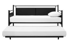 a black metal daybed with white pillows