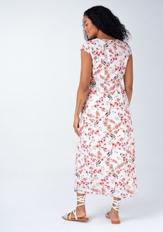 A beautiful bohemian midi dress in a rose pink floral print, with sexy side cutouts. Cotton blend Floral print Relaxed fit Short cap sleeves Mid-length V-neckline Half-elastic waist at the back Self-covered button front Side waist cutouts Women's bohemian spring dress Sexy side-waist cutouts elevate this classic mid-length dress. Designed in a cheerful floral print, with short cap sleeves, a self-covered button front, and a flattering v-neckline. Perfect for spring and summer, we love to pair it V-neck Beach Dress With Rose Print, Feminine Floral Print Maxi Dress With Surplice Neckline, Summer V-neck Dress With Rose Print, Beach Floral Print Midi Dress With Surplice Neckline, Beach Midi Dress With Surplice Neckline And Floral Print, Floral Midi Dress With Surplice Neckline For Beach, Spring Cap Sleeve Maxi Dress, Spring V-neck Maxi Dress With Rose Print, Floral Print Rayon Midi Dress With V-neck