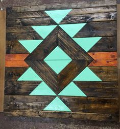 a wooden wall hanging with an arrow painted on it's side and wood planks in the middle