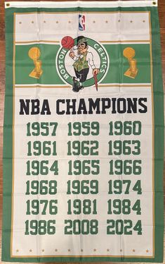 the basketball tournament banner is displayed on a wooden table with other sports memorabilia in front of it