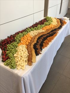 a table topped with lots of different types of food on top of a white table cloth