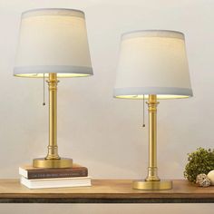 two lamps sitting on top of a wooden table