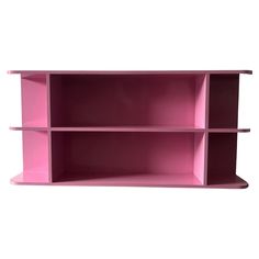 a pink shelf sitting on top of a white wall