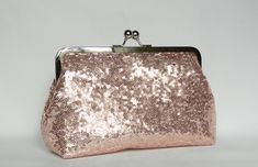 NOTE: ALL OF MY BAGS ARE HANDMADE TO CUSTOMERS INDIVIDUAL ORDERS!! Gorgeous and Elegant. A beautiful handmade Rose Gold sequin clutch purse, fully lined with pink satin fabric. Reinforced with heavy weight interlining and interfacing so it maintains its shape. All stress points have been double stitched for durability. The size is perfect to carry your essentials for a day or night out, i.e mobile phones, keys, make-up, credit cards and coins. The purse as well as many others in my collection wo Pink Satin Fabric, Gold Sequin Fabric, Bridal Bags, Wedding Clutch Purse, Silk Clutch, Bridesmaid Clutches, Clutch Bag Wedding, Sequin Clutch, Velvet Clutch