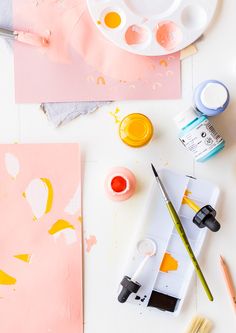 some paint and brushes are sitting on a table