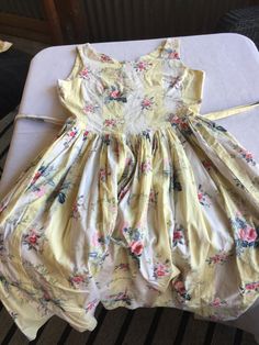 "Retro Cotton Gathered Sleeveless Sundress, gathered skirt with buttoned waist ties that tie in the back like an apron. Has a back zipper, and looks maybe handmade, as there's no tag or lining. (Very cool in the summer because there's no lining and it's pure cotton. VERY classic 50s summer dress, perfect for Easter parties or barbeques. It doesn't have a size tag, but I'd say it was a 10 based on the measurements. Laying flat, it looks like it's 35\" at the bust, 31\" at the waist, and huge at t Daywear Sleeveless Dress With Fitted Bodice, Sleeveless Dresses With Fitted Bodice For Daywear, Spring Vintage Sleeveless Dress For Parties, Sleeveless Dress With Gathered Skirt And Fitted Bodice, Sleeveless Floral Print Vintage Dress, Sleeveless Dress With Fitted Bodice And Tie Back, Spring Sleeveless Vintage Sundress, Sleeveless Fitted Vintage Dress For Casual Wear, Knee-length Tie-back Daywear Dress