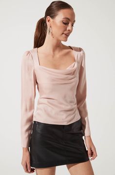 A dressy top for any occasion. It features a flattering cowl neck that descends to a fitted bodice and features a statement cutout back. Long sleeves. Smocked back. Pink Fitted Top For Fall, Spring Evening Tops In Solid Colors, Versatile Fitted Long Sleeve Top For Night Out, Versatile Evening Tops For Fall, Plain Tops For Evening In Spring, Fitted Long Sleeve Top For Brunch In Fall, Chic Fitted Long Sleeve Top For Evening, Chic Foldover Top Blouse For Fall, Chic Fall Blouse With Foldover Top