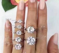 a woman's hand with four different types of engagement rings on her fingers and the measurements