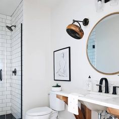 a white bathroom with black and white accessories