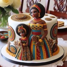 a cake decorated with an african woman and child