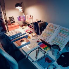 a desk with books, headphones and other items on it in an office space