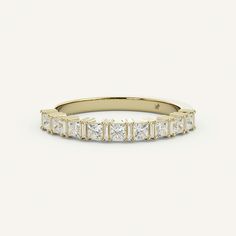 a yellow gold band with princess cut diamonds