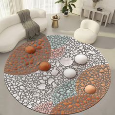 a living room with white couches and an artistic rug on the floor that looks like pebbles