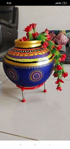 a blue vase with red flowers in it