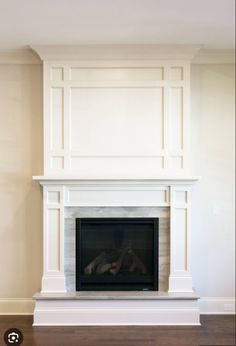 an empty fireplace with white paint on the mantle