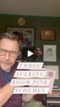 a man holding up three signs that read three suking room pink schemes