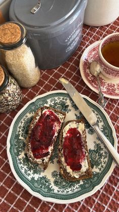 two pieces of toast on a plate with jam in the middle and other ingredients around it