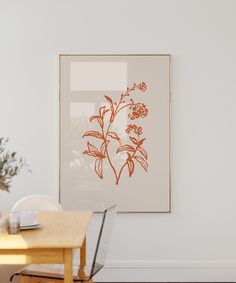 a dining room table with a laptop on it next to a vase filled with flowers