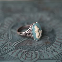 18x13mm turquoise and white acrylic mermaid cameo. On an antiqued brass cigar band style ring. Easy to adjust to most sizes. Available in both antiqued silver and antiqued brass. I also have a matching necklace in my shop (see in last photo). Vintage Cameo Ring, Collectible Adjustable Cameo Jewelry, Ella Outfit, Formal Silver Cameo Rings, Elegant Cameo Rings, Antique Poison Rings, Mermaid Rings, Antique Silver Cameo Rings, Victorian Silver Cameo Rings