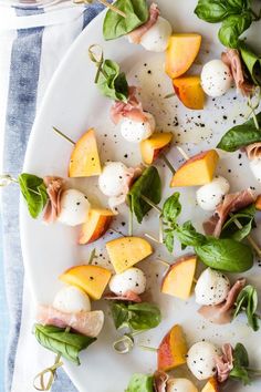 a white plate topped with mozzarella and peaches