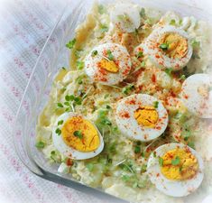 an image of a dish with eggs and potatoes in it on a tablecloth background