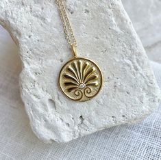 Please note that this necklace is custom made to order. Please allow 6 weeks for your order to ship. Handcrafted of solid 14K gold and a single diamond, this coin features an Ancient Greek Palmette, a symbol of eternity and divinity. Coin measures 17mm. 3.30 grams. Pendant can be purchased separately or attached to an 16, 18 or 20 inch chain. Please make your selection at checkout. Ancient Greek Jewelry Museum Of Jewelry, Mythology Jewelry Ancient Treasures, Ancient Greek Jewelry Ancient Treasures, Luxury Ancient Style Pendant Jewelry, Luxury Ancient Collectible Jewelry, Luxury Antique Gold Medallion Jewelry, Persian Ancient Jewelry, Ancient Greek Jewelry 1stdibs, Luxury Symbolic Coin Pendant Necklace