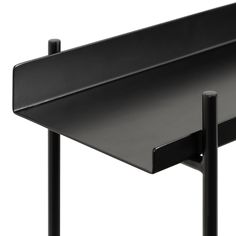 a black table with two metal legs and a shelf on the top that is holding an object