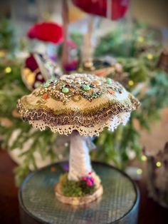 a table topped with a cake covered in lots of beads and other things on top of it