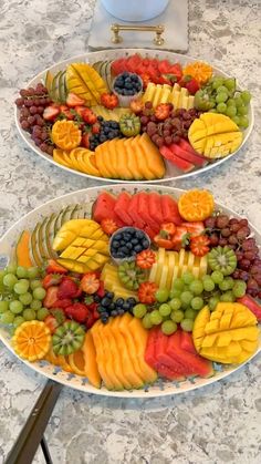 two platters filled with different types of fruit