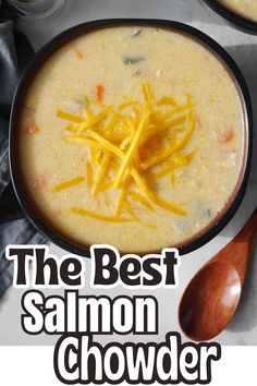 the best salmon chowder soup recipe is in a bowl with cheese on top and spoons next to it