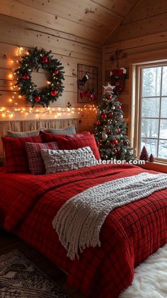 a bedroom decorated for christmas with red and white bedding, plaid comforter, wreaths and lights on the wall