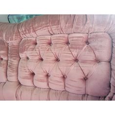 an upholstered pink velvet headboard with buttons