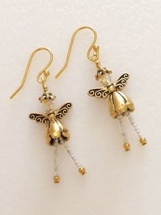 two small gold and crystal beaded fairy dangles are hanging from earwires