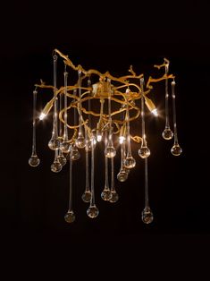 a chandelier with many lights hanging from it's sides and some glass balls in the middle