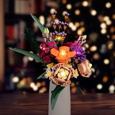 a vase filled with flowers on top of a wooden table