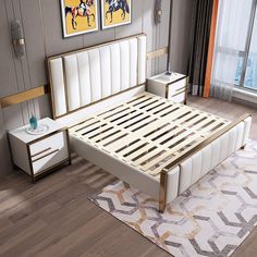 a white bed sitting on top of a hard wood floor next to a wall mounted painting