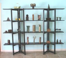 a room with shelves filled with vases and other items