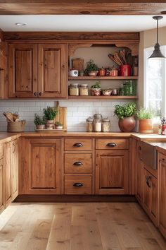 a kitchen filled with lots of wooden cupboards and counter top space next to a window