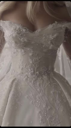 a woman in a wedding dress is posing for the camera