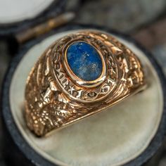 This awesome vintage West Point US Military Academy ring from 1961 features a lapis cabochon center stone. A personal engraving "with love Alan" remains visible. The ring has gentle overall wear, including some on the lapis, but is in great condition. The ring is currently a size 5. Luxury Heirloom Men's Cabochon Ring, Vintage Sapphire Oval Cabochon Ring Hallmarked, Vintage Oval Cabochon Sapphire Ring Hallmarked, Vintage Oval Cabochon Sapphire Ring, Vintage Oval Cabochon Sapphire Ring With Hallmark, Vintage Sapphire Ring With Oval Cabochon, Vintage Gold Sapphire Cabochon Ring, Vintage Gold Sapphire Ring With Cabochon, Gold Vintage Sapphire Cabochon Ring