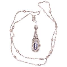 Beautiful and Finely detailed Platinum Diamond and Blue Sapphire accents Watch Pendant Necklace and Diamond set matching chain. Hand crafted in Platinum. Chain measures approx. 24 inches. This pendant epitomizes vintage charm and would make a lovely compliment to any outfit. The necklace and pendant are in excellent condition and were recently professionally cleaned and polished. Illuminate your look with Timeless Beauty with this Family Heirloom Quality Keepsake, to have and to hold Forever! Vintage Diamond Medallion Jewelry, Vintage Platinum Necklace For Anniversary, Vintage Platinum Necklace As A Gift, Vintage Platinum Necklace For Gift, Vintage Platinum Pendant Necklace, Vintage Platinum Necklace For Formal Occasions, White Gold Vintage Necklace With Vintage Charm, Vintage White Gold Necklaces With Vintage Charm, Antique Platinum Jewelry And Watches As Gifts