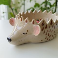 a ceramic hedgehog planter sitting on top of a table