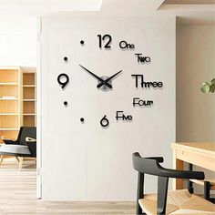 a clock that is on the side of a wall in a room with wooden floors